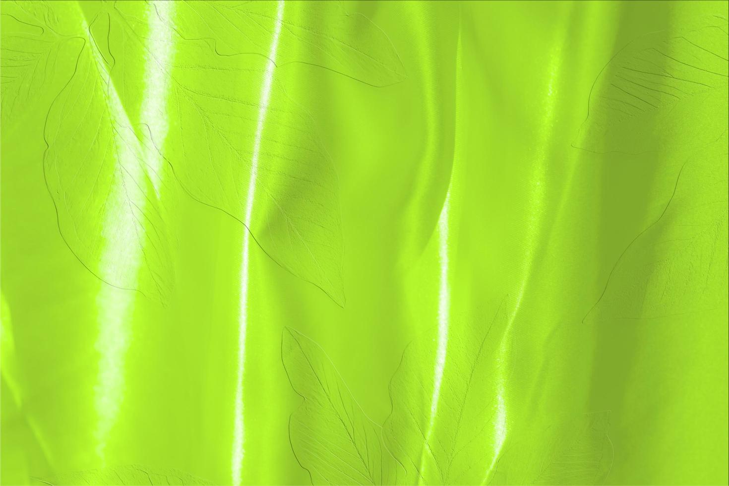 green satin fabric texture soft blur with palm leaves pattern background photo