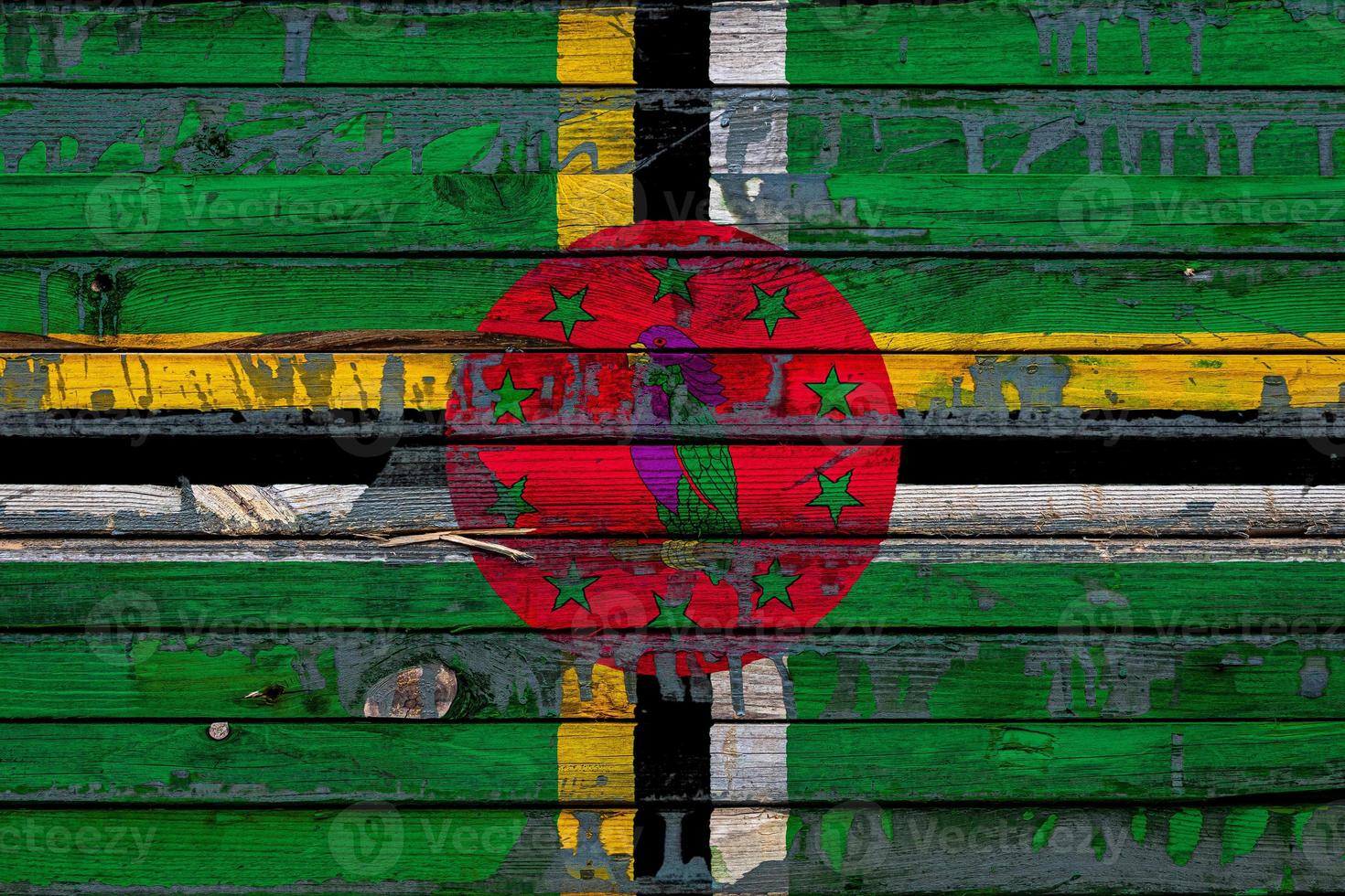 The national flag of Dominica is painted on uneven boards. Country symbol. photo