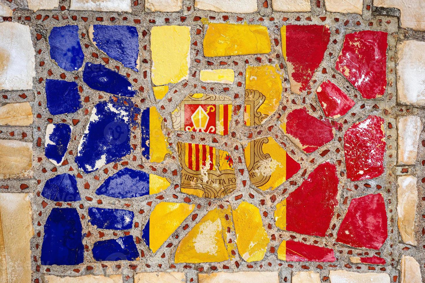 National flag of Andorra on stone  wall background. Flag  banner on  stone texture background. photo