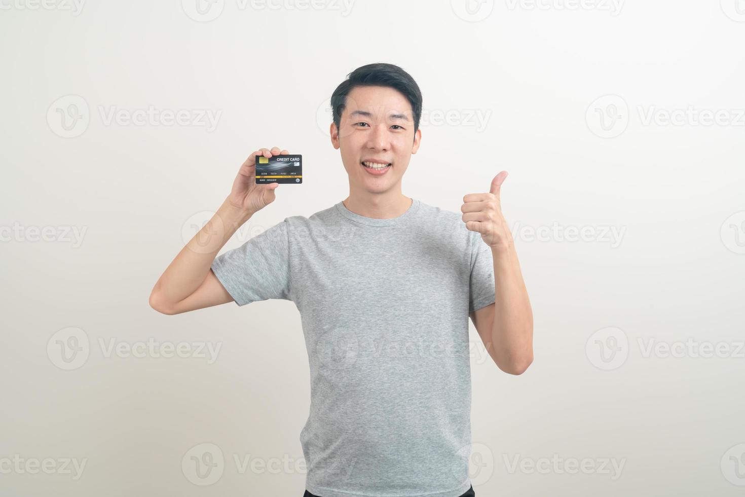 young Asian man holding credit card photo