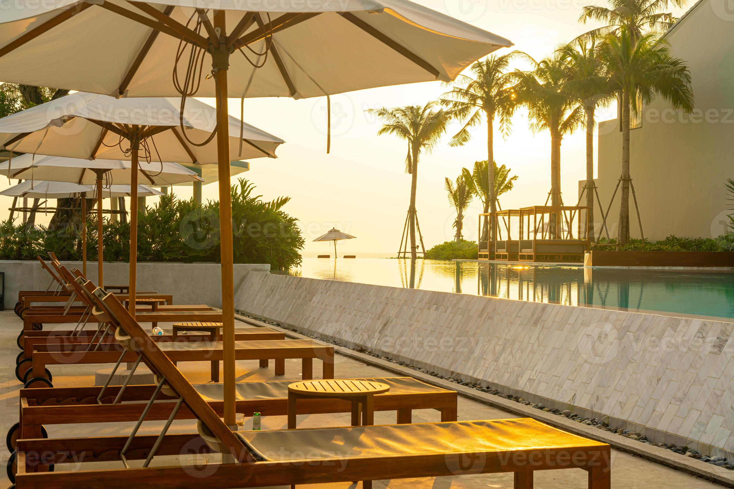 umbrella with bed pool around swimming pool with ocean sea background