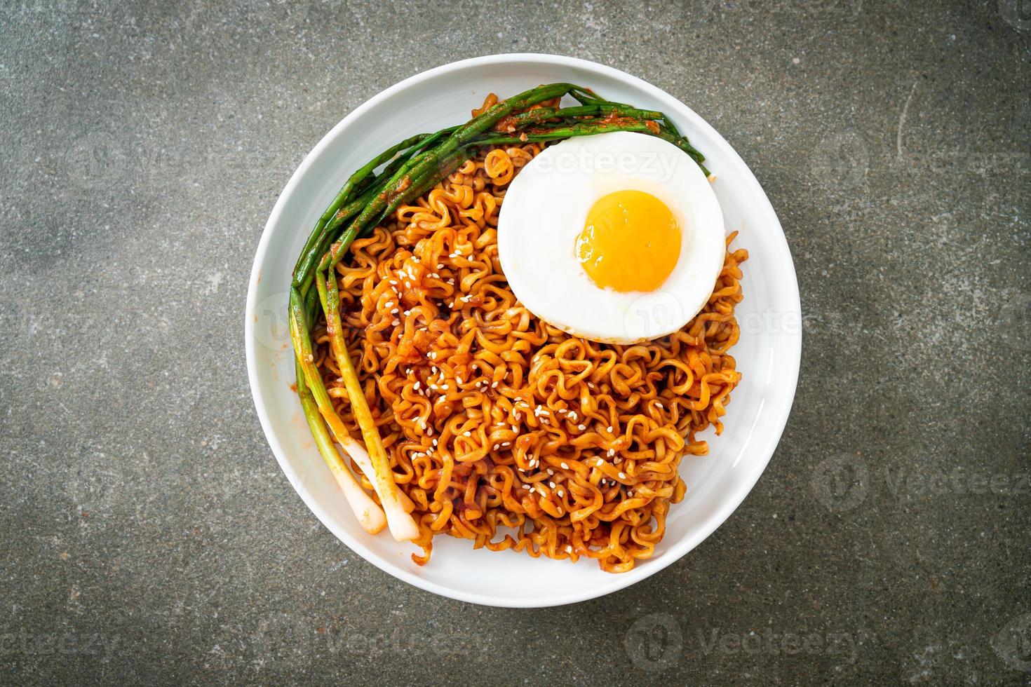 dried Korean spicy instant noodles with fried egg photo