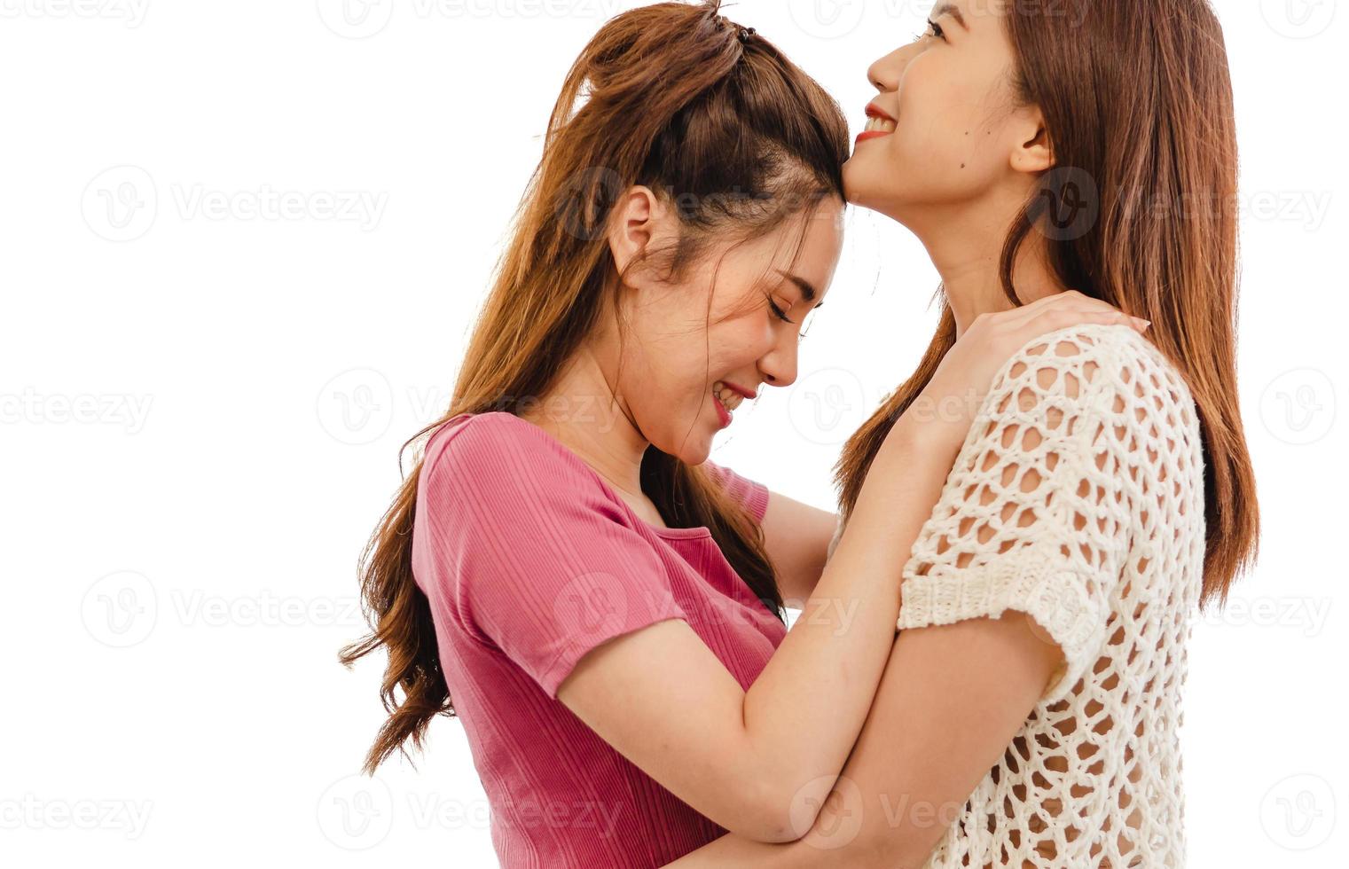 Romantic gay lesbians holding each other smiling. Asian homosexual couple intimate moment embracing in bedroom isolated on white background. Portrait, two women hugging with affectionate relationship photo