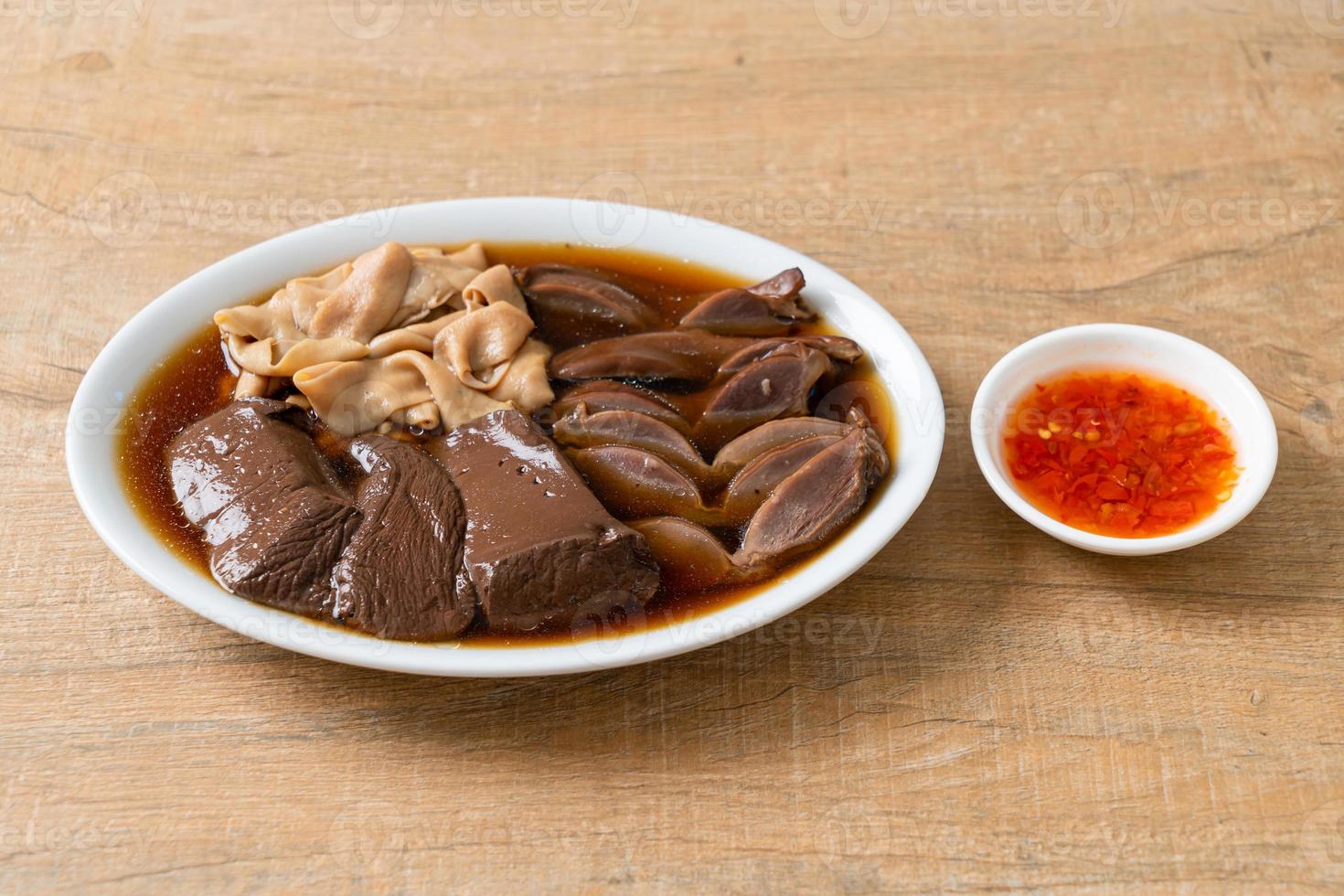stewed duck offal in brown soup photo