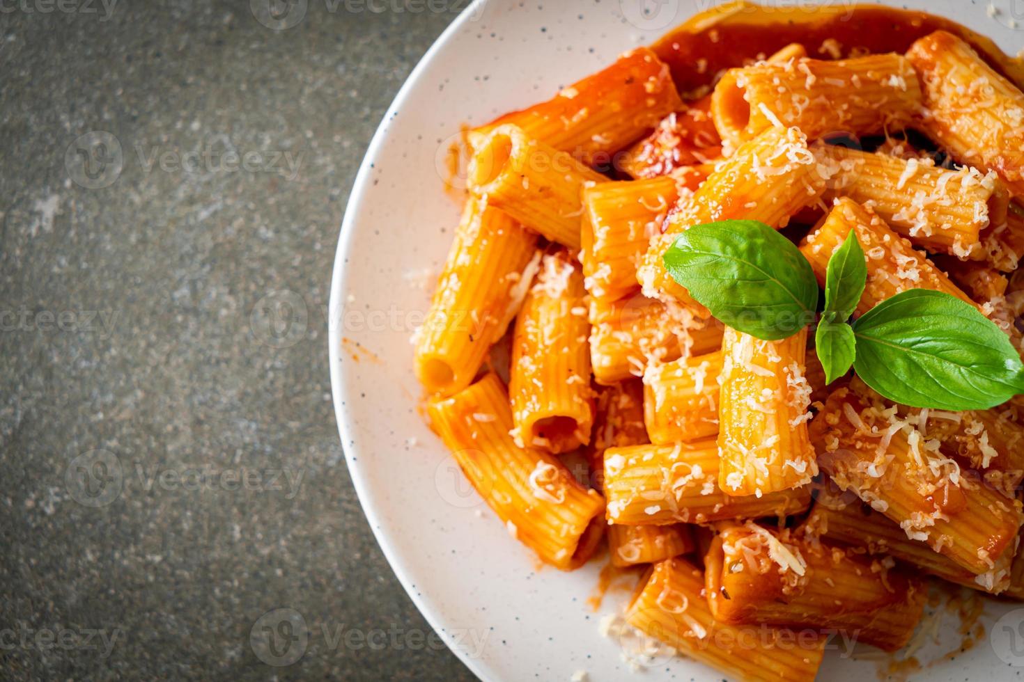 Rigatoni pasta with tomato sauce and cheese photo