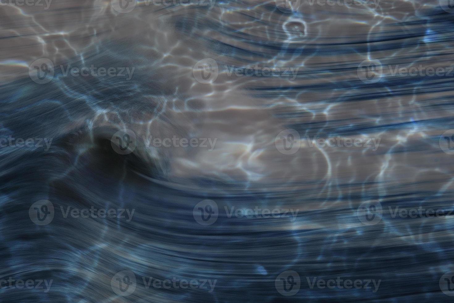 Defocus blurred water in swimming pool rippled water detail background photo