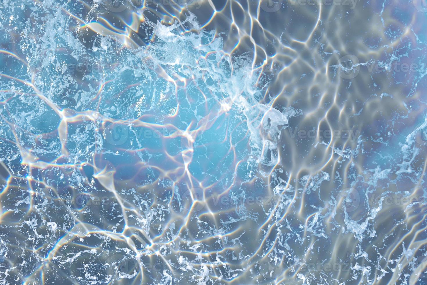Defocus blurred water in swimming pool rippled water detail background photo