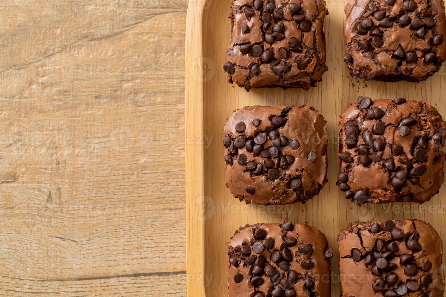 dark chocolate brownies topped by chocolate chips photo