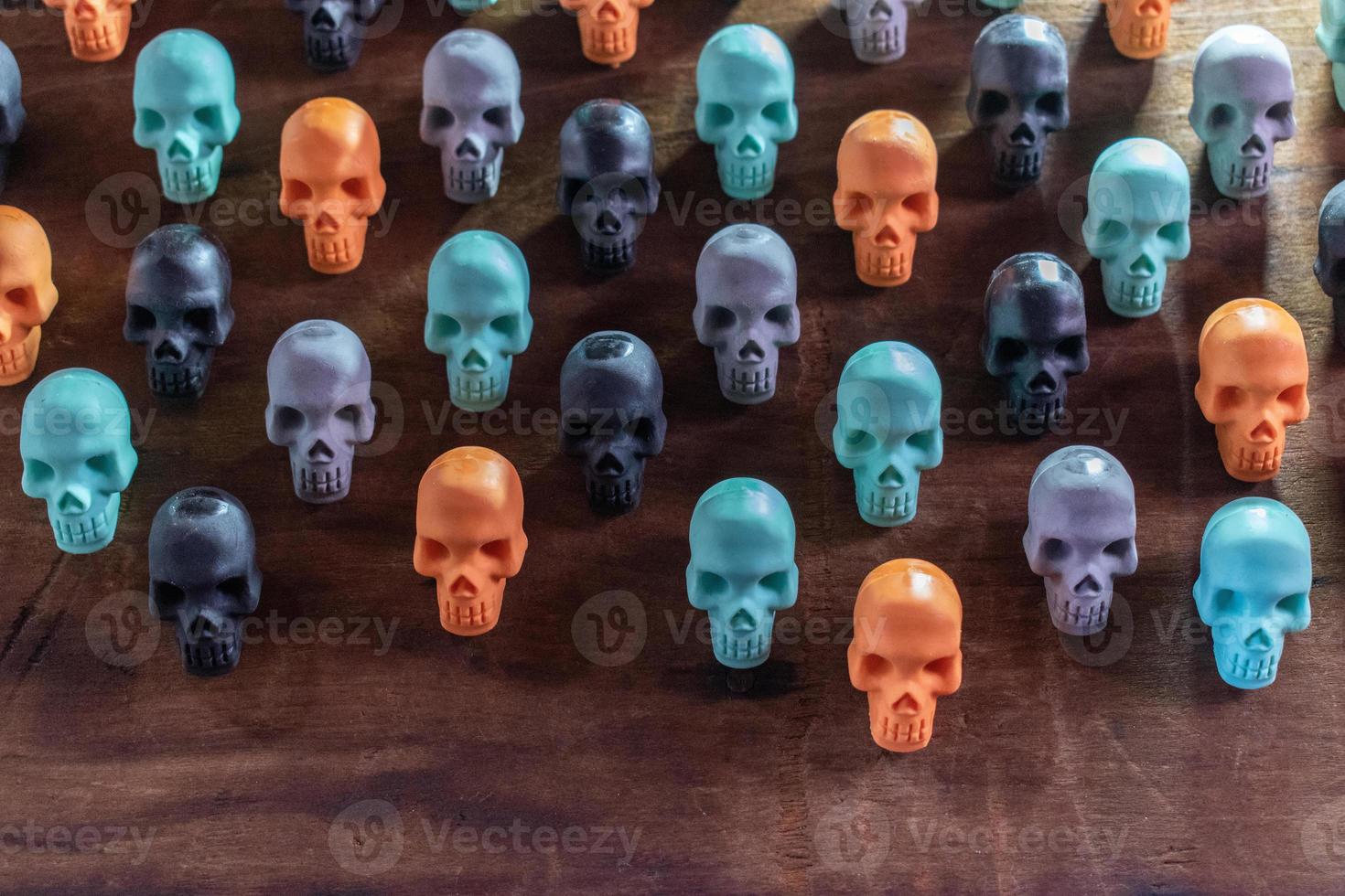 background of colorful Halloween skulls laid out in pattern photo