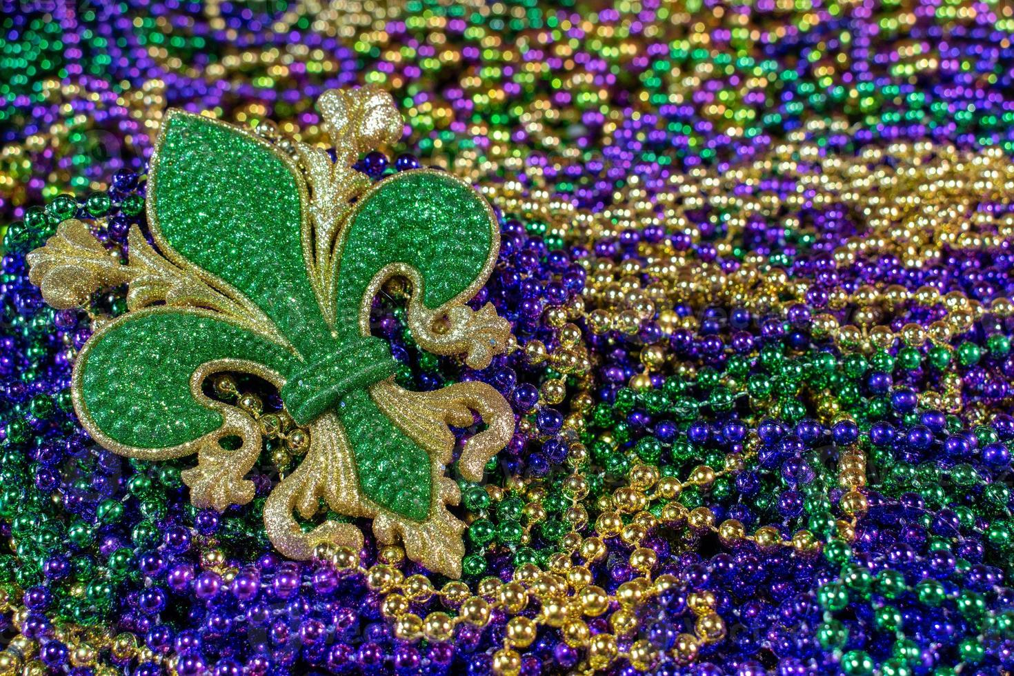 Pile of Mardi Gras beads with fleur de lis photo