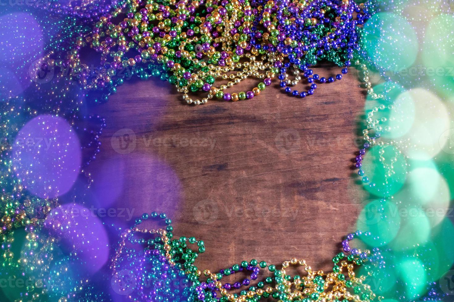 Mardi Gras border of beads with bokeh with copy space photo