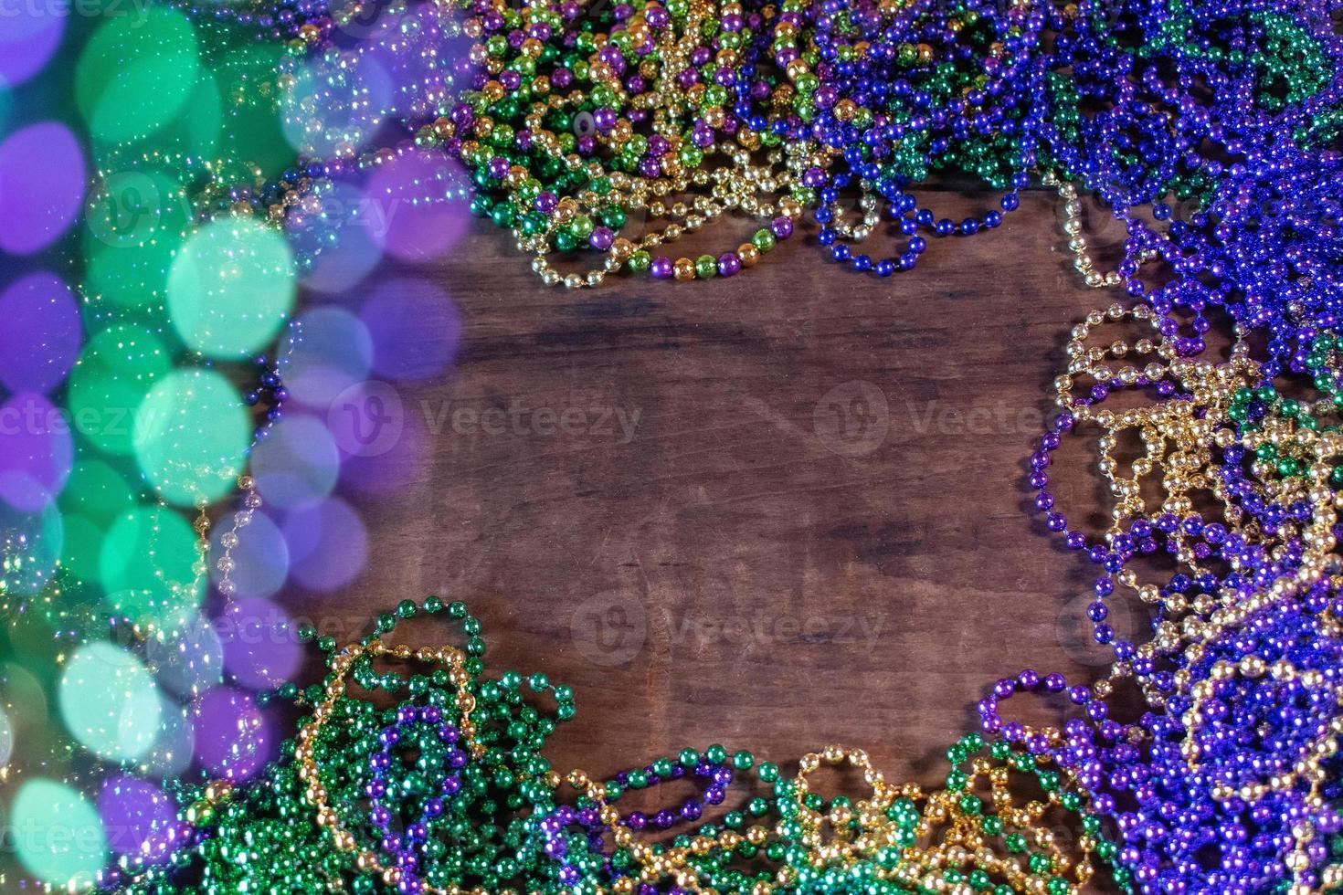 Mardi Gras border of beads with bokeh with copy space photo