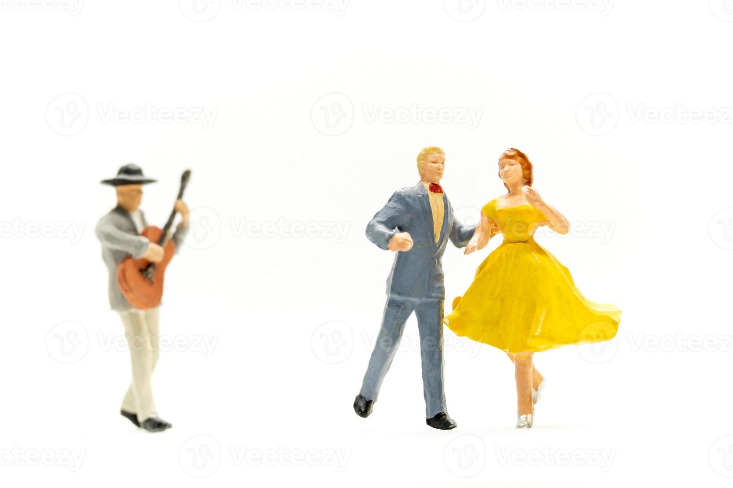 Miniature people Couple dancing with a guitarist playing the guitar photo