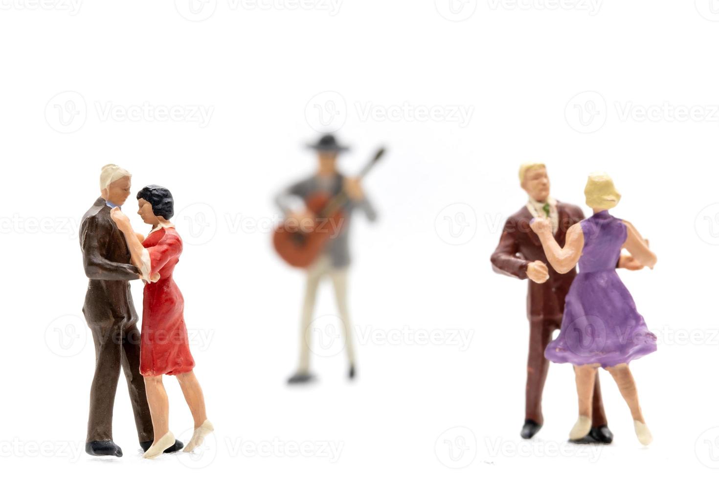 Miniature people Couple dancing with a guitarist playing the guitar photo