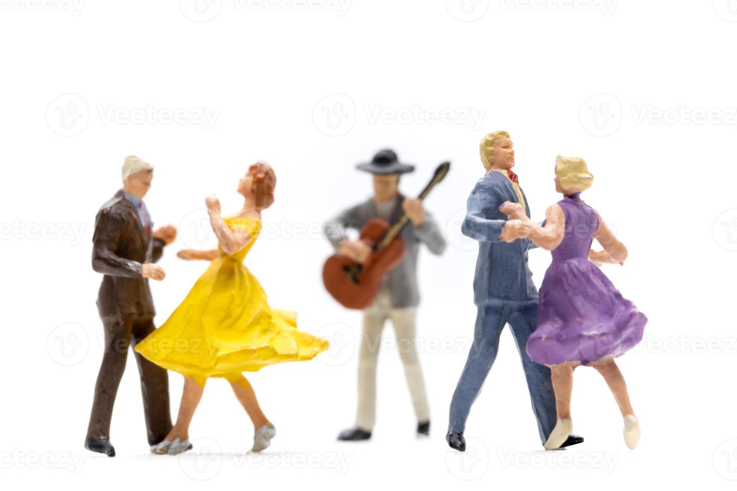Miniature people Couple dancing with a guitarist playing the guitar photo