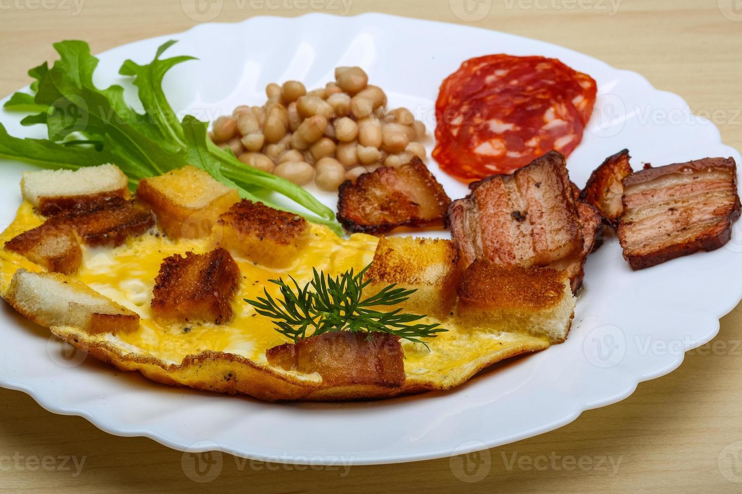 Breakfast with eggs, bacon and beans photo