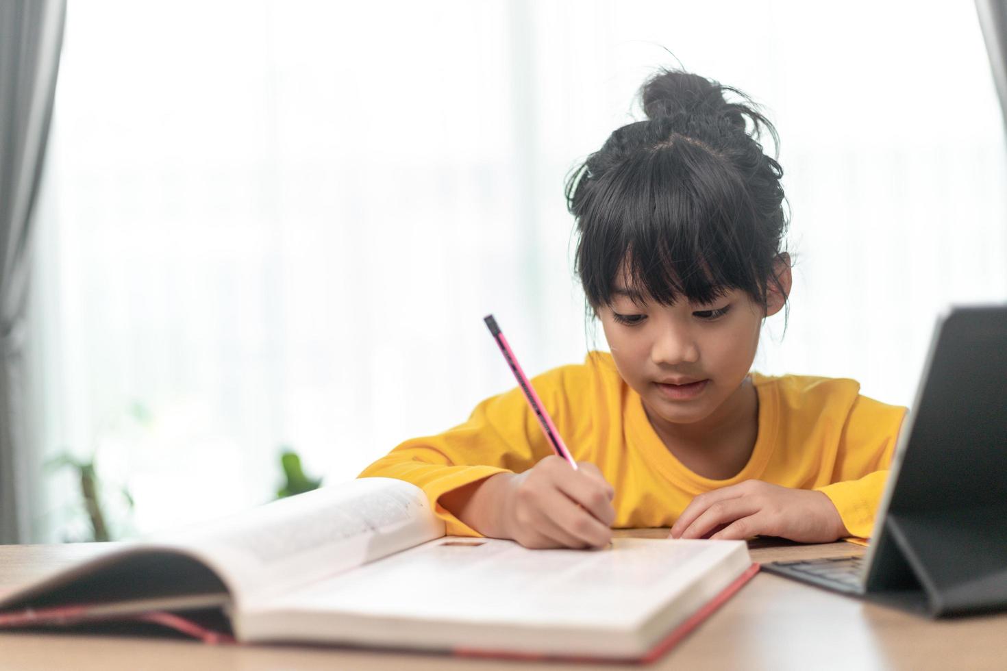 Asian little girl taking class on line and happy for Homeschool Quarantine coranavirus pandemic concept photo