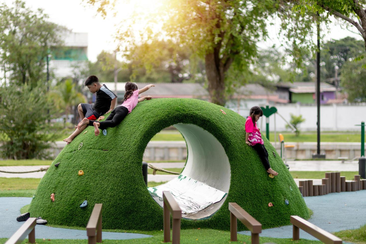 The cute kids are resting in the playground in summer photo