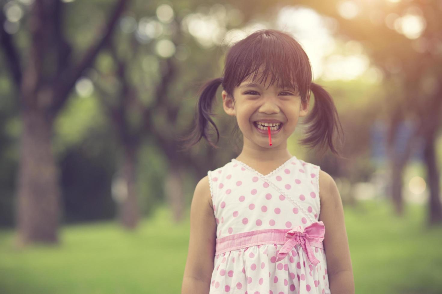 happy little girls with lollipops outdoors.Vintage color photo