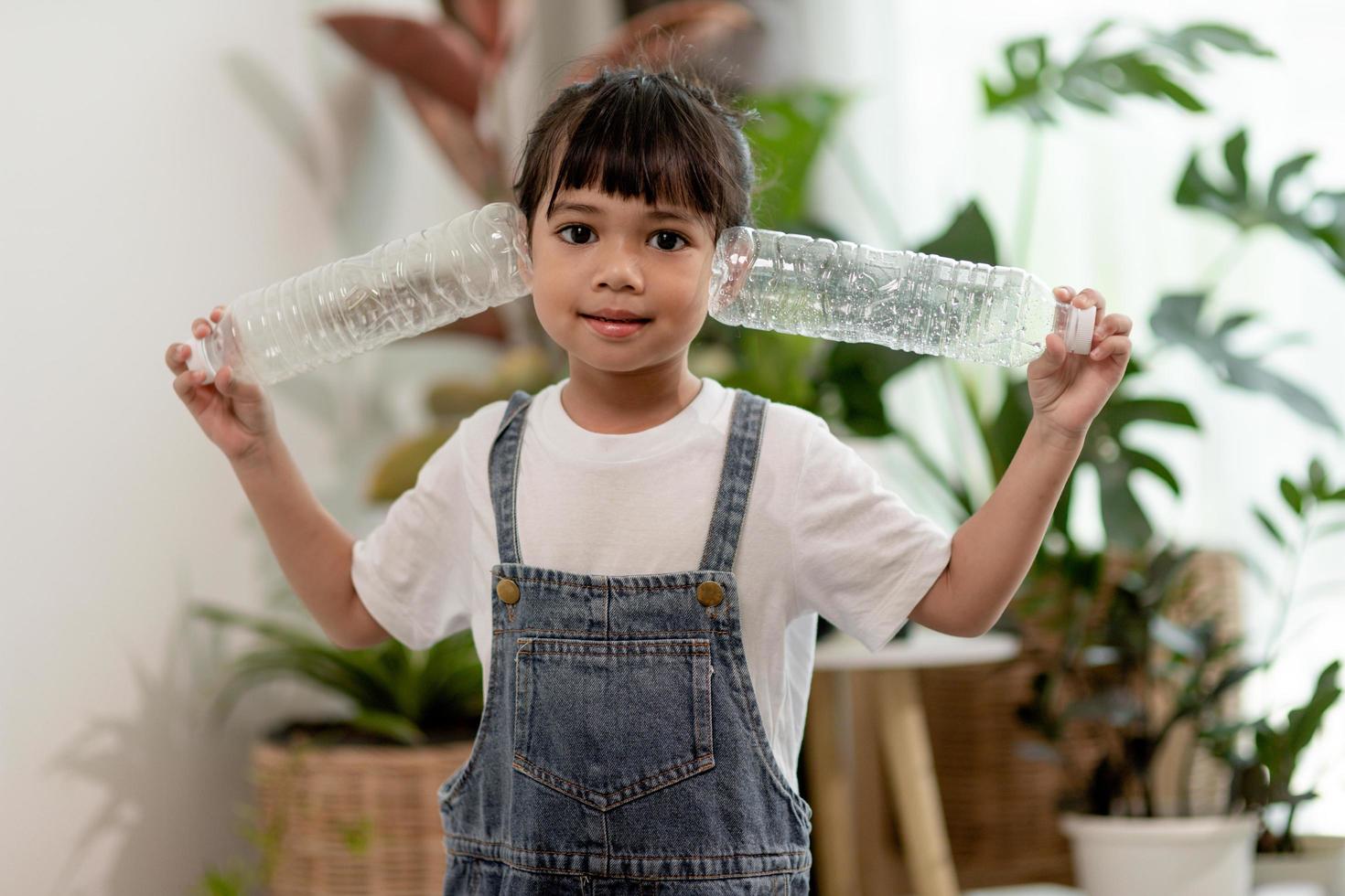 Asian Little girl is separate trash to recycle photo