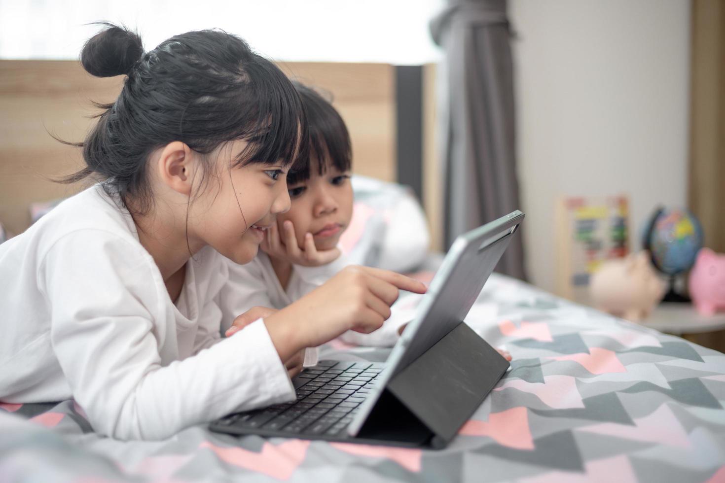 Asian little girl taking class on line and happy for Homeschool Quarantine coranavirus pandemic concept photo