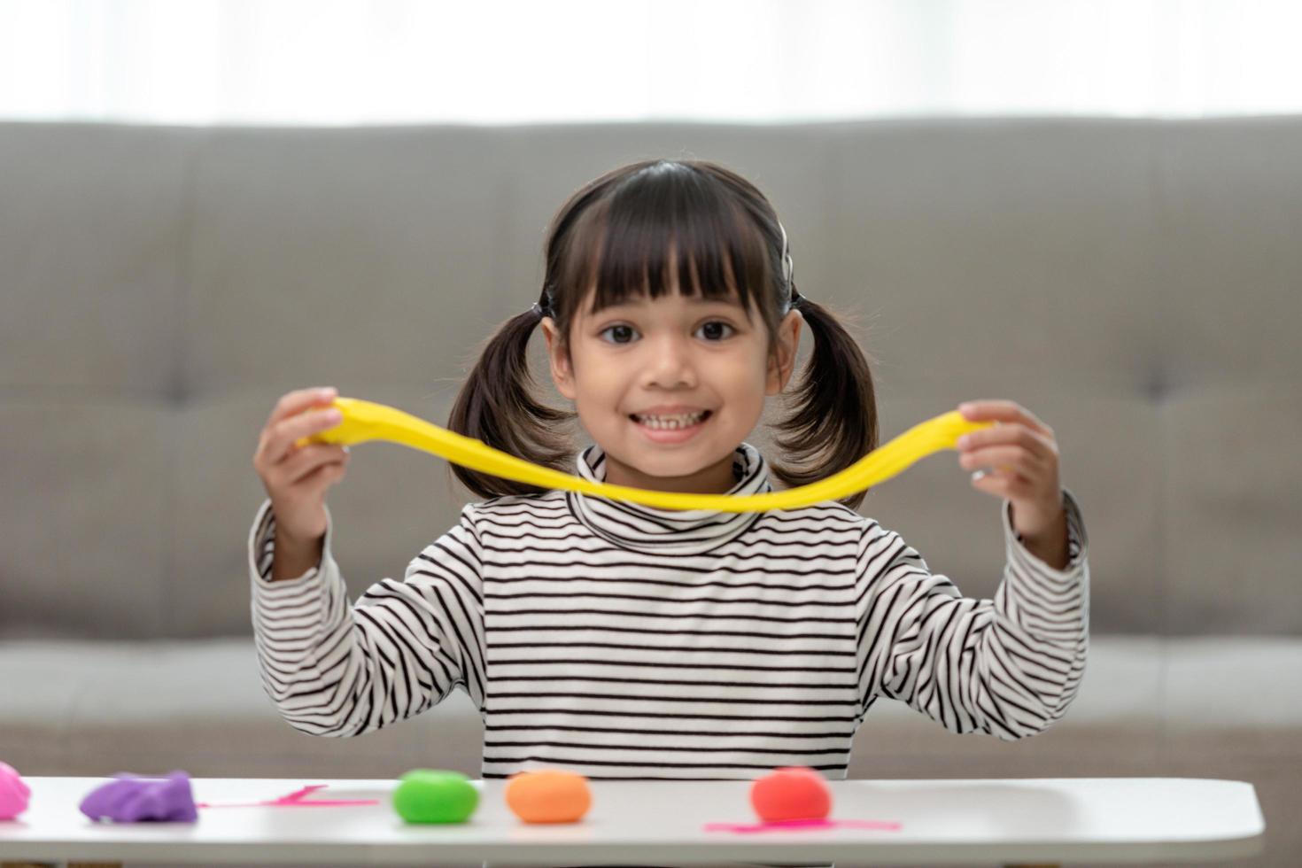 Asian kids play with clay molding shapes, learning through play photo