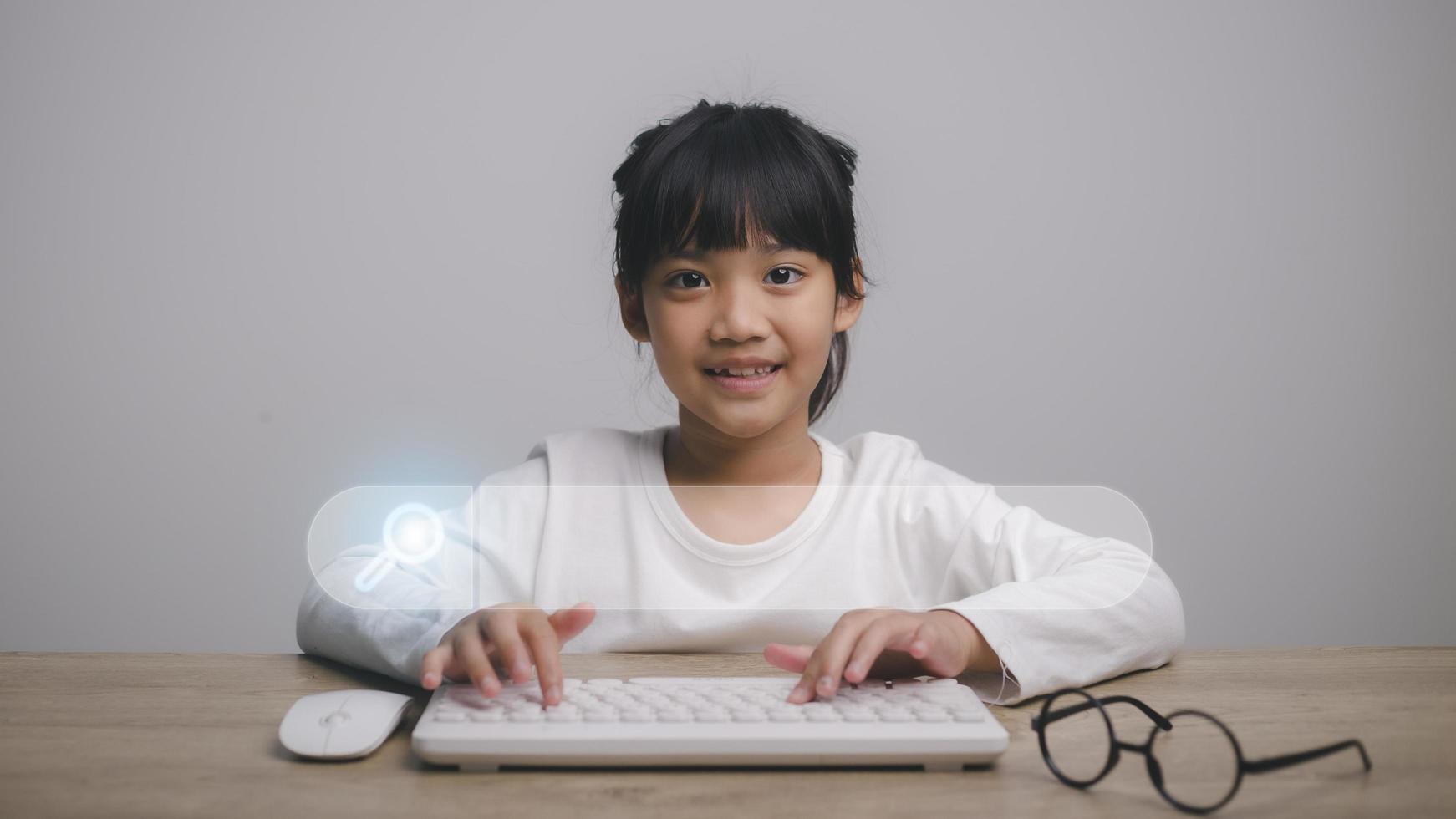 smart kids, Data Search Technology Search Engine Optimization. Cute girl hands are using a mouse and computer keyboard to Searching for information. Using Search Console with your website. photo