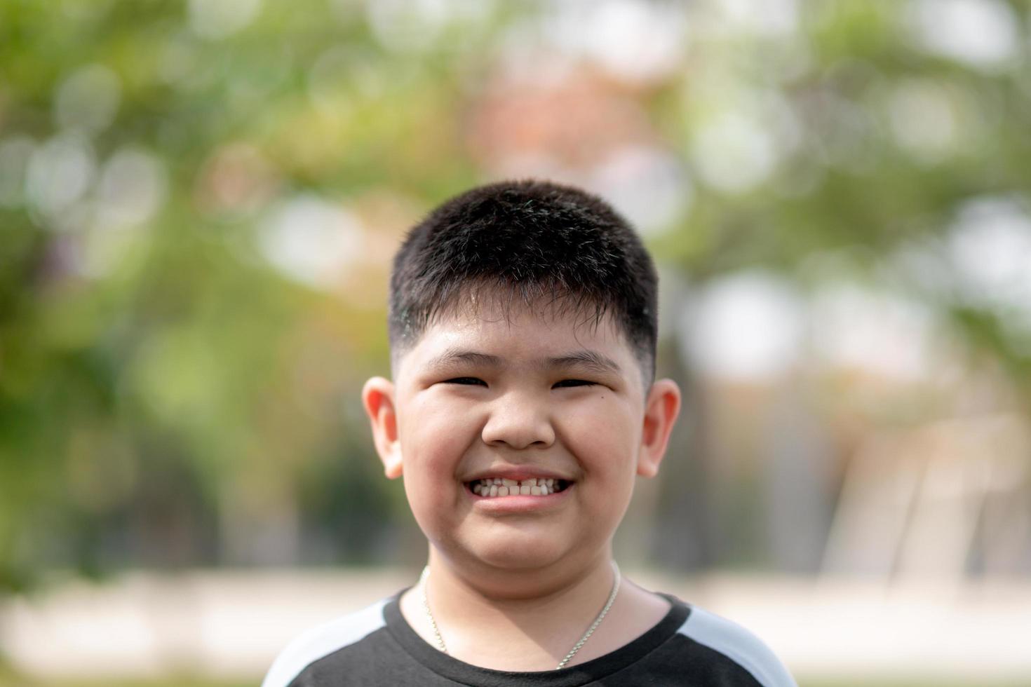 Portrait of cute Asian child little Thai boy smile makes a happy face concept. photo