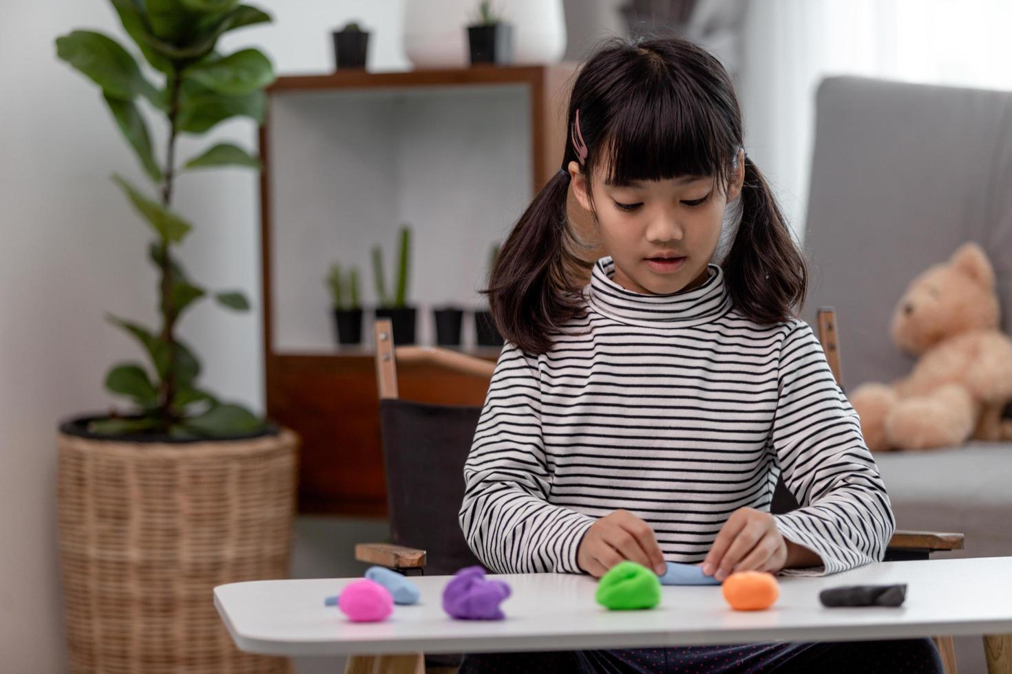 Asian kids play with clay molding shapes, learning through play photo