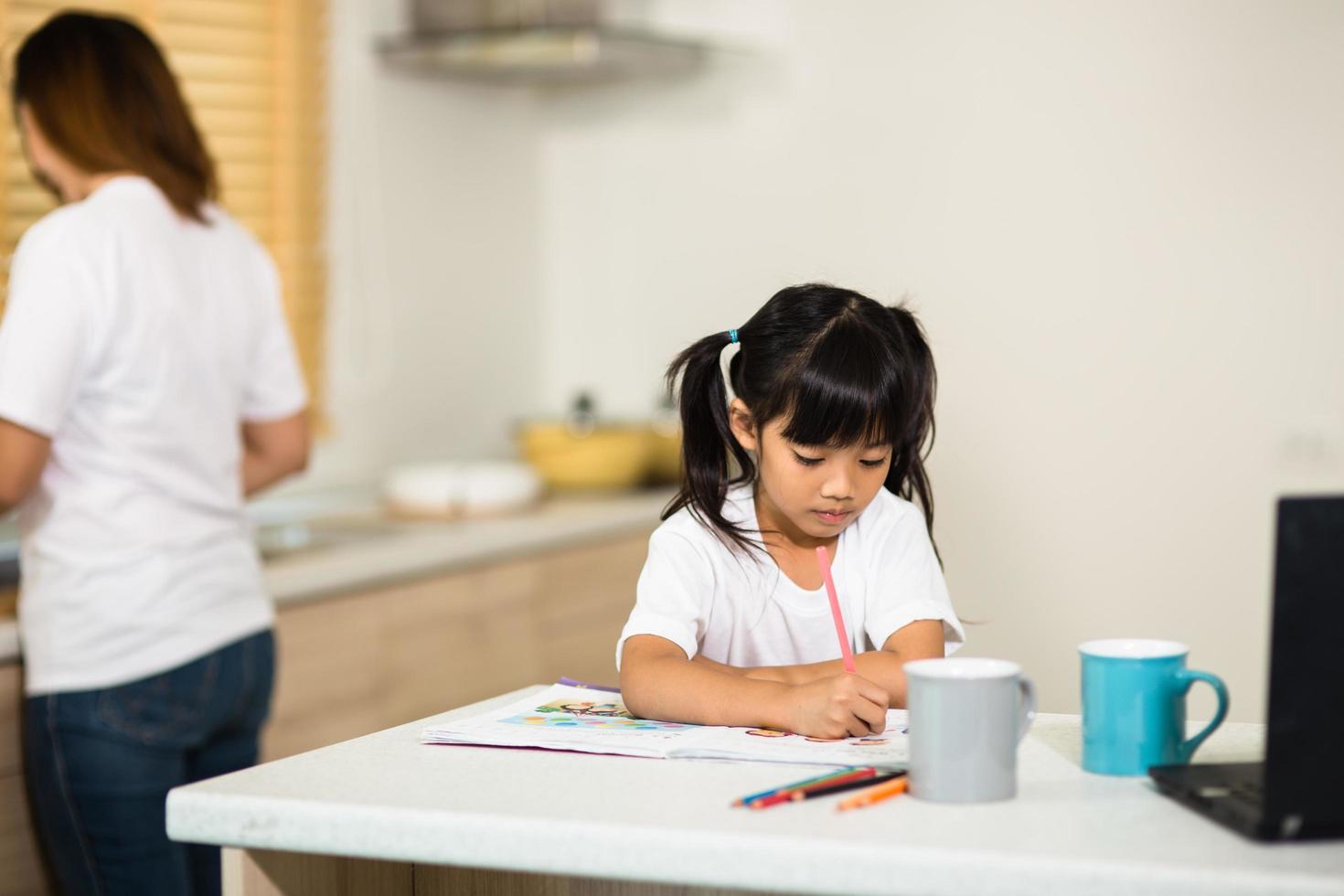 Coronavirus Outbreak. Lockdown and school closures. Schoolgirl watching online education class, happy talking with teacher on the internet at home. COVID-19 pandemic forces children online learning photo