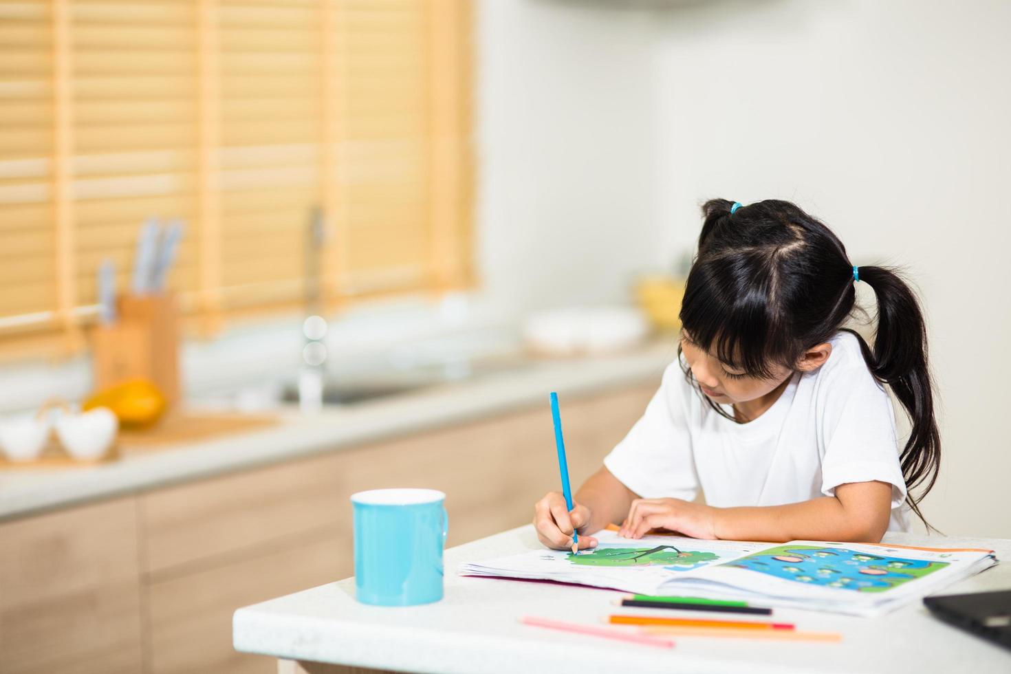 Coronavirus Outbreak. Lockdown and school closures. Schoolgirl watching online education class, happy talking with teacher on the internet at home. COVID-19 pandemic forces children online learning photo