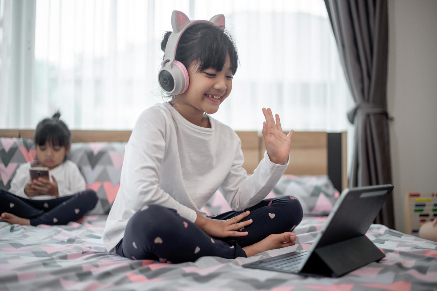 Asian little girl taking class on line and happy for Homeschool Quarantine coranavirus pandemic concept photo