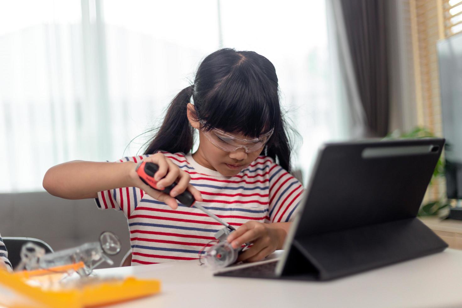 Female Student Building And Programing Robot Vehicle In After School Computer Coding Class photo