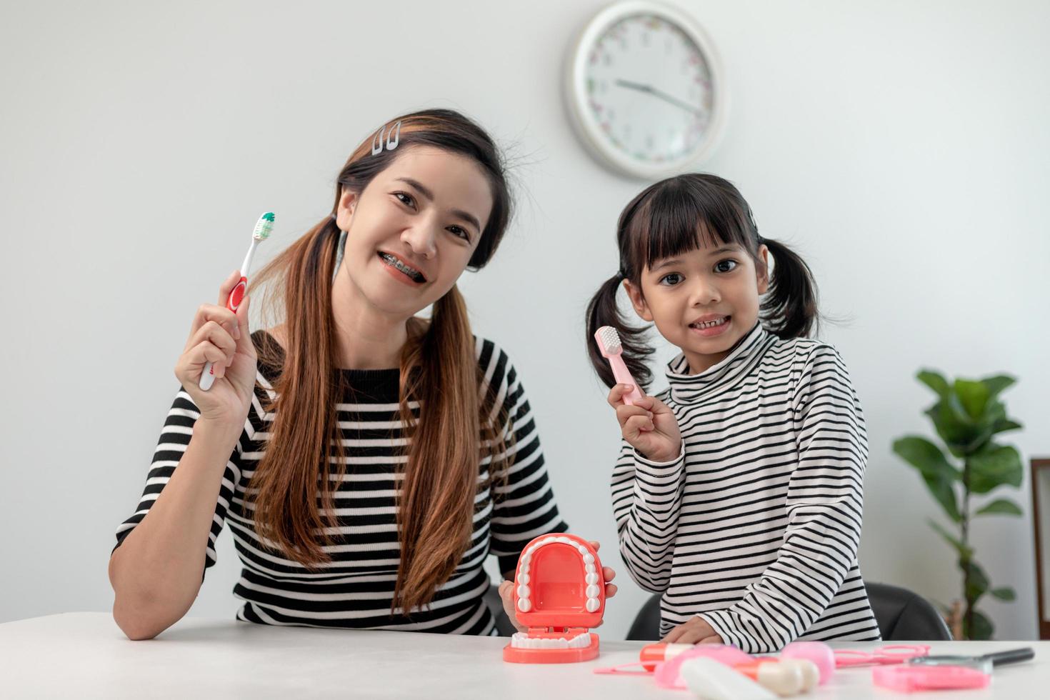 Happy family and health. mother and daughter girl brushing their teeth together photo