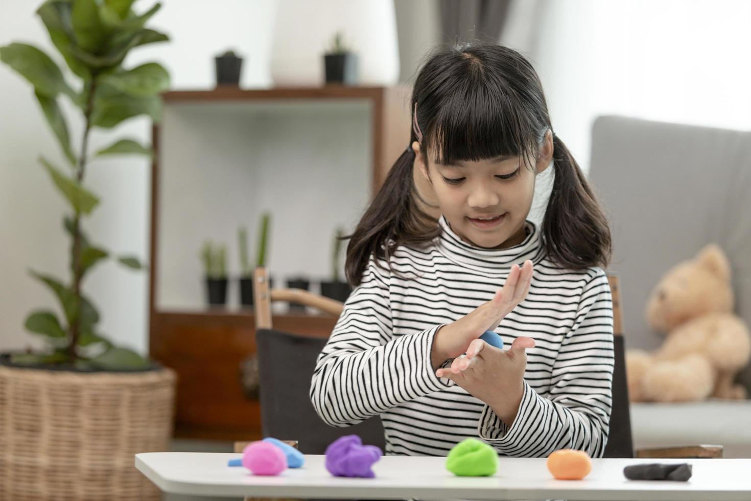 Asian kids play with clay molding shapes, learning through play photo