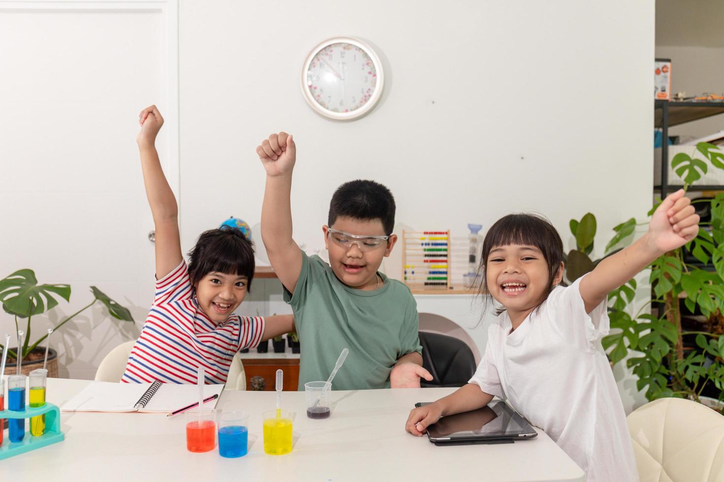 Asian kids do chemical experiments in their home photo