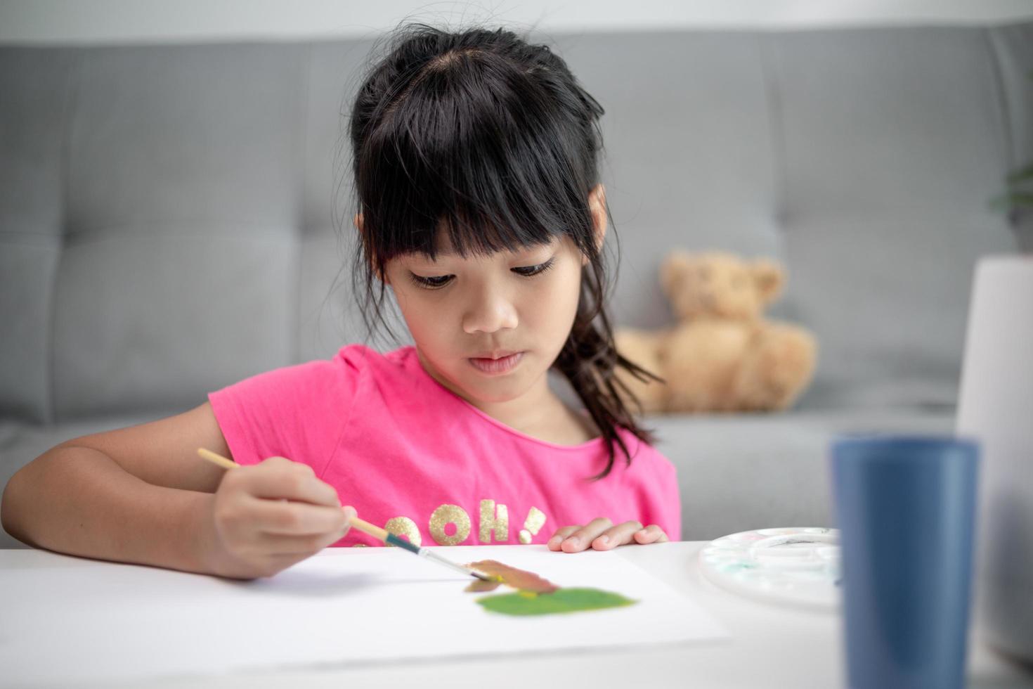 Girl Painting Picture On Table At Home photo