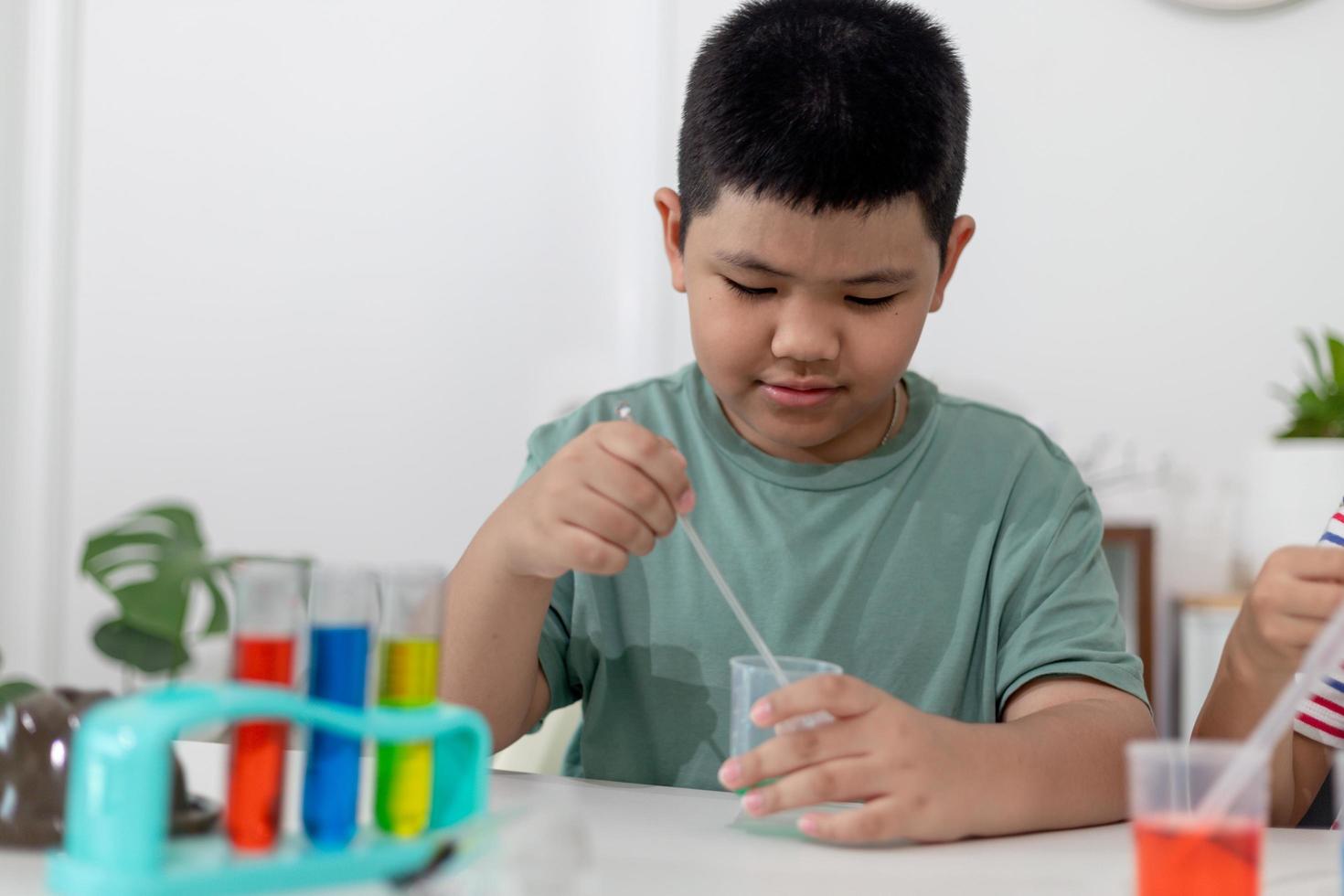 Asian Children enthusiastically watch chemistry experiments. photo