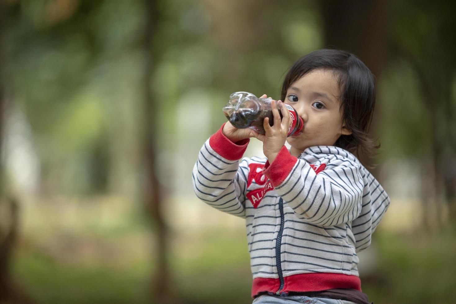 little girl drink cola photo