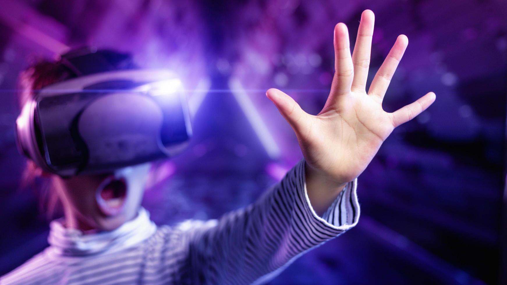 Happy girl in glasses of virtual reality. augmented reality, science, future technology concept. vr. futuristic 3d glasses with virtual projection photo