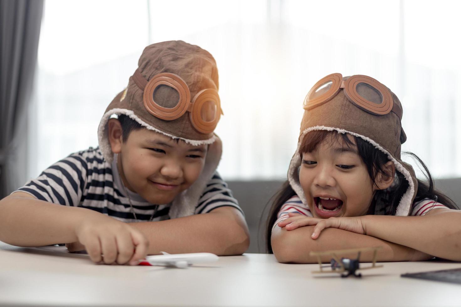 Two children with airplanes in hands photo