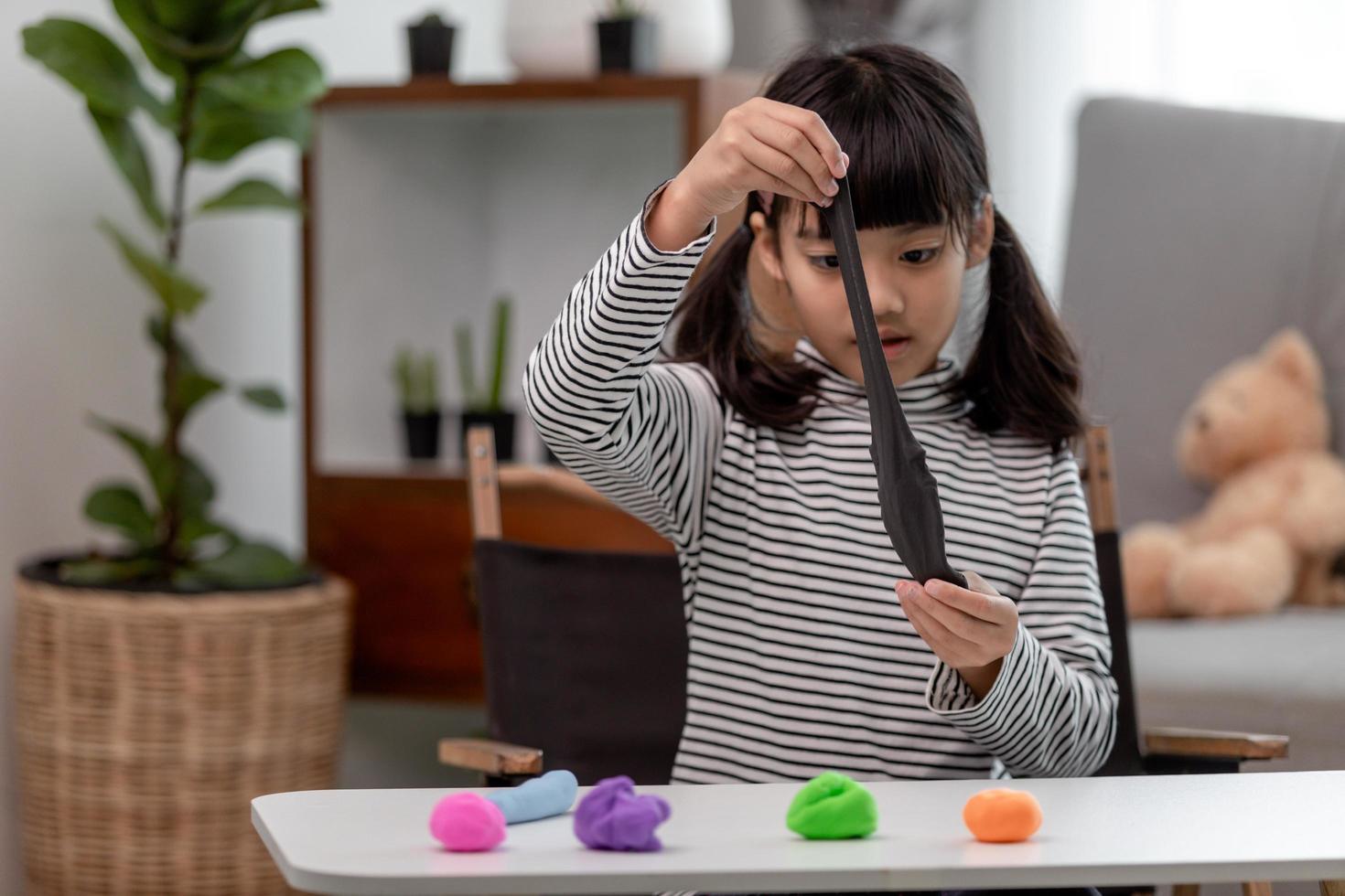 Asian kids play with clay molding shapes, learning through play photo