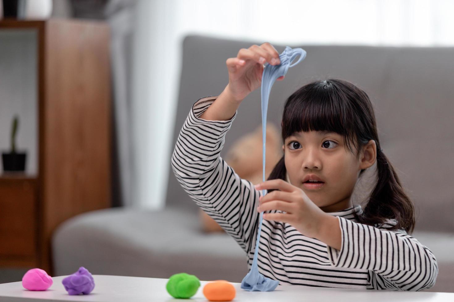 Asian kids play with clay molding shapes, learning through play photo