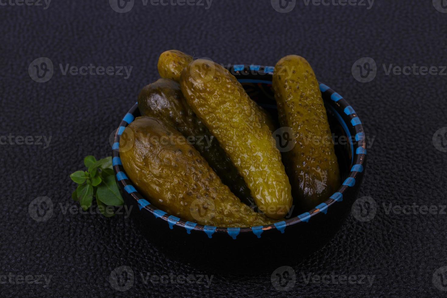 Pickled cucumbers heap in the bowl photo