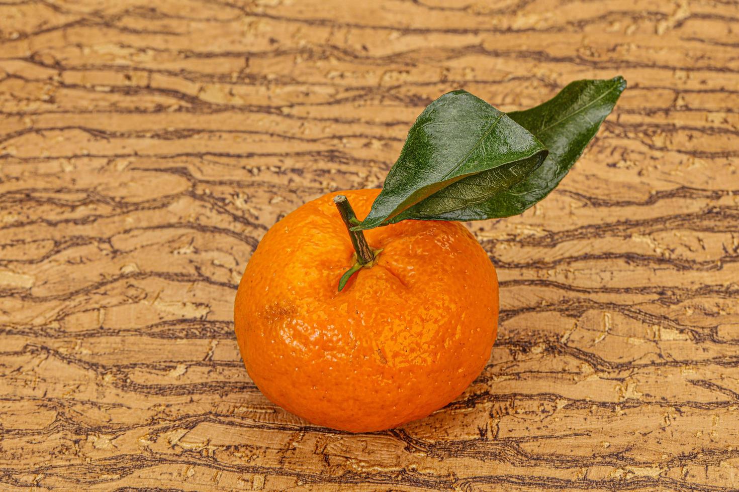 Ripe sweet tasty tangerine with leaves photo