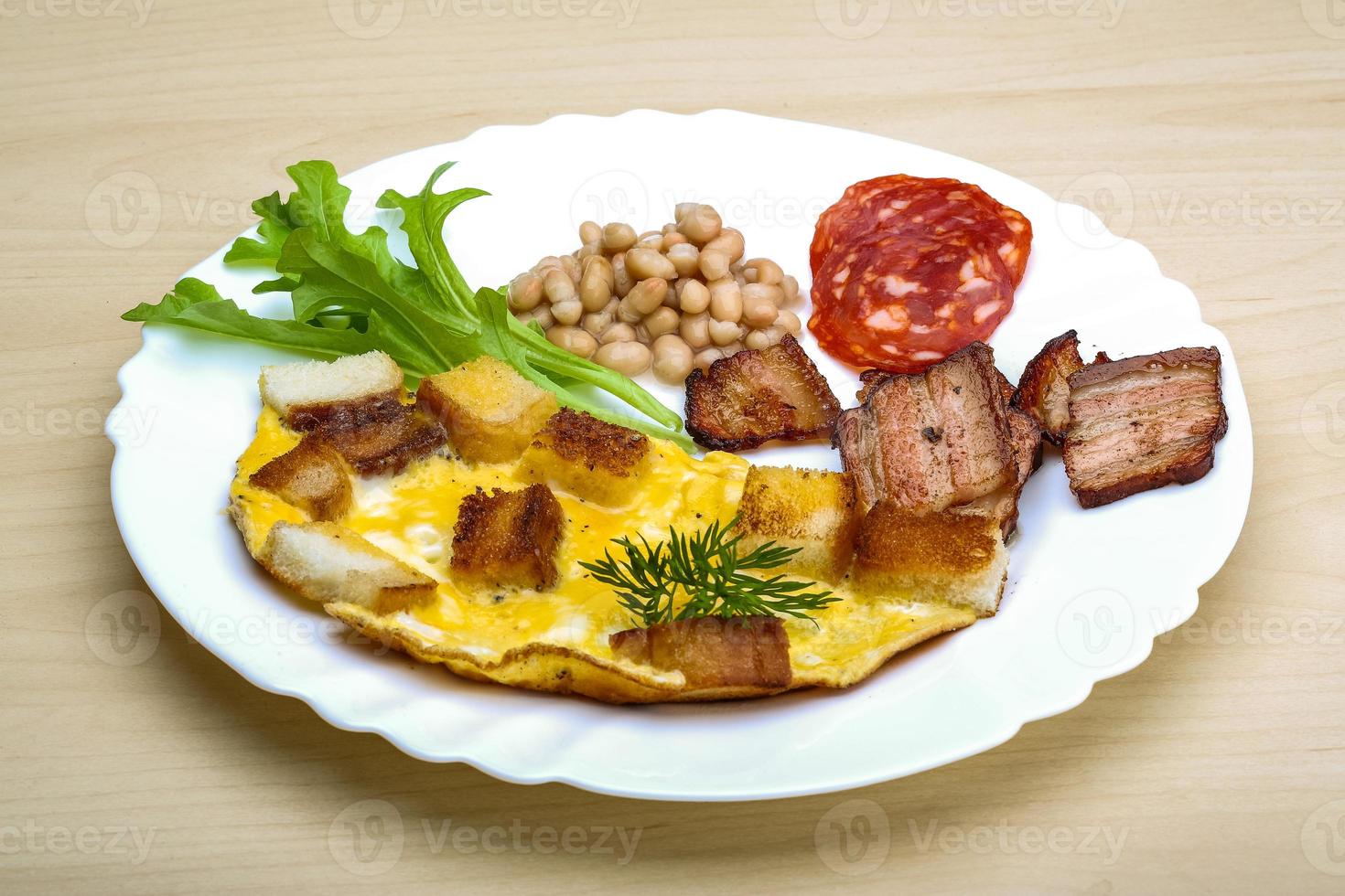 Breakfast with eggs, bacon and beans photo