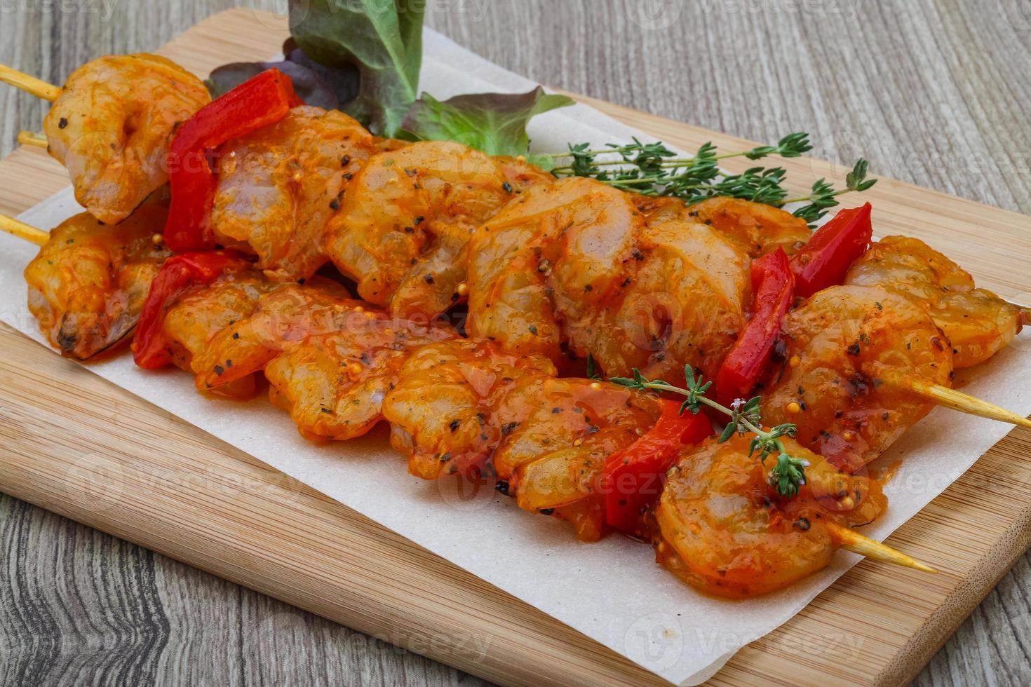 Raw tiger shrimps skewer photo