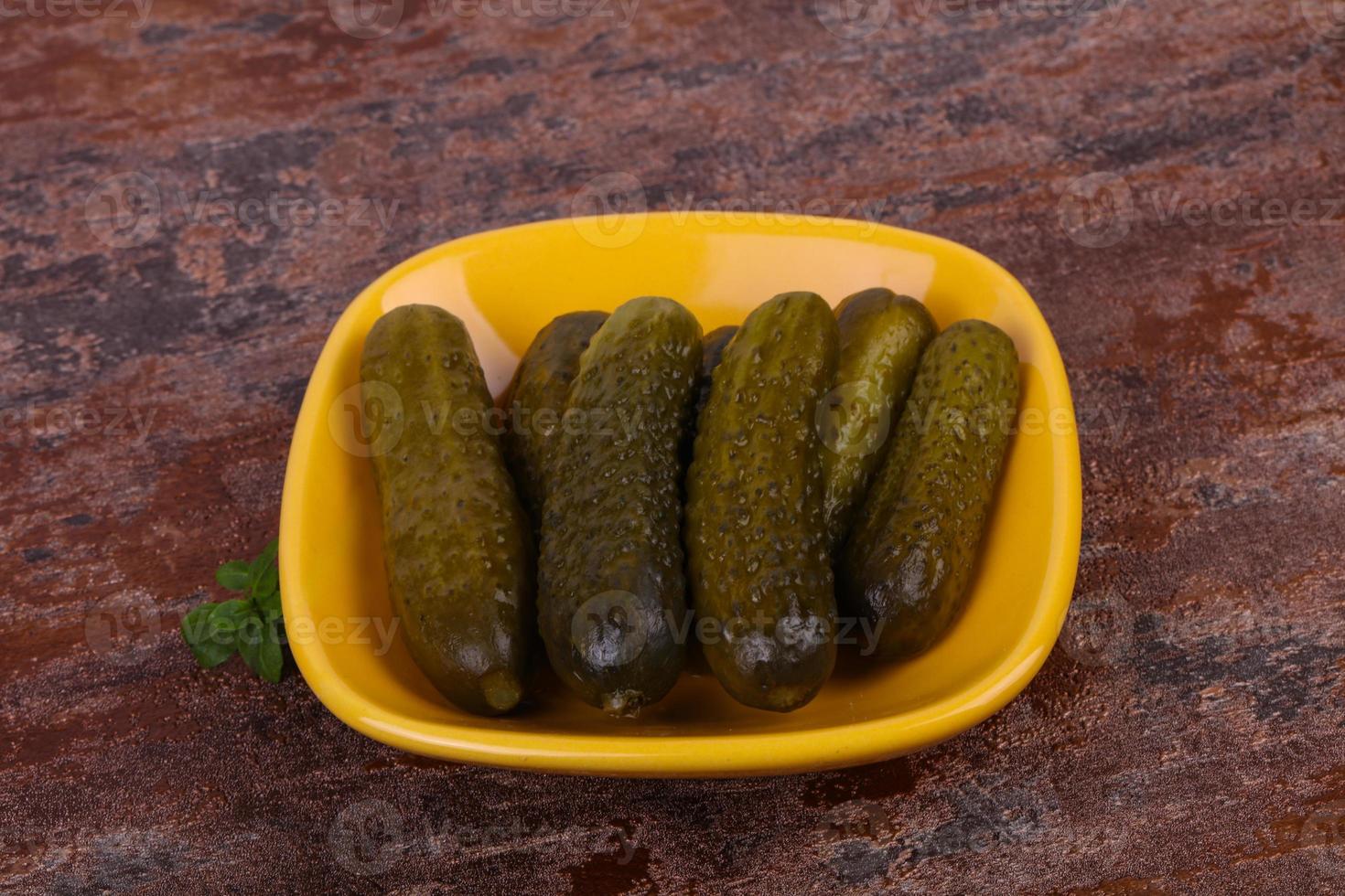 Pickled cucumbers heap in the bowl photo