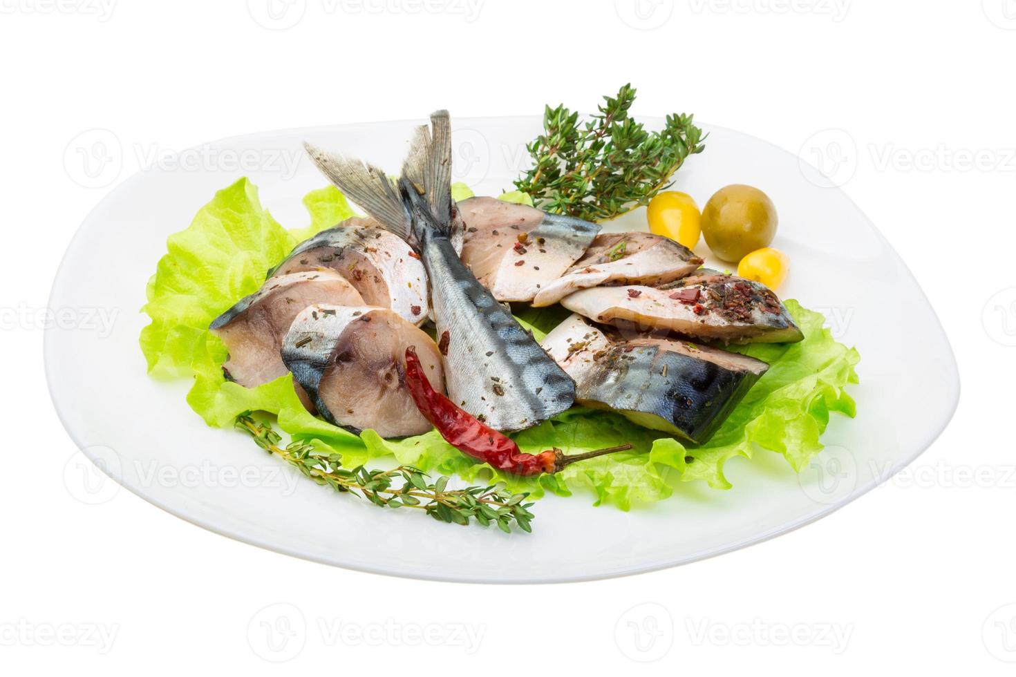 Mackerel fish, sliced on a plate with lettuce photo