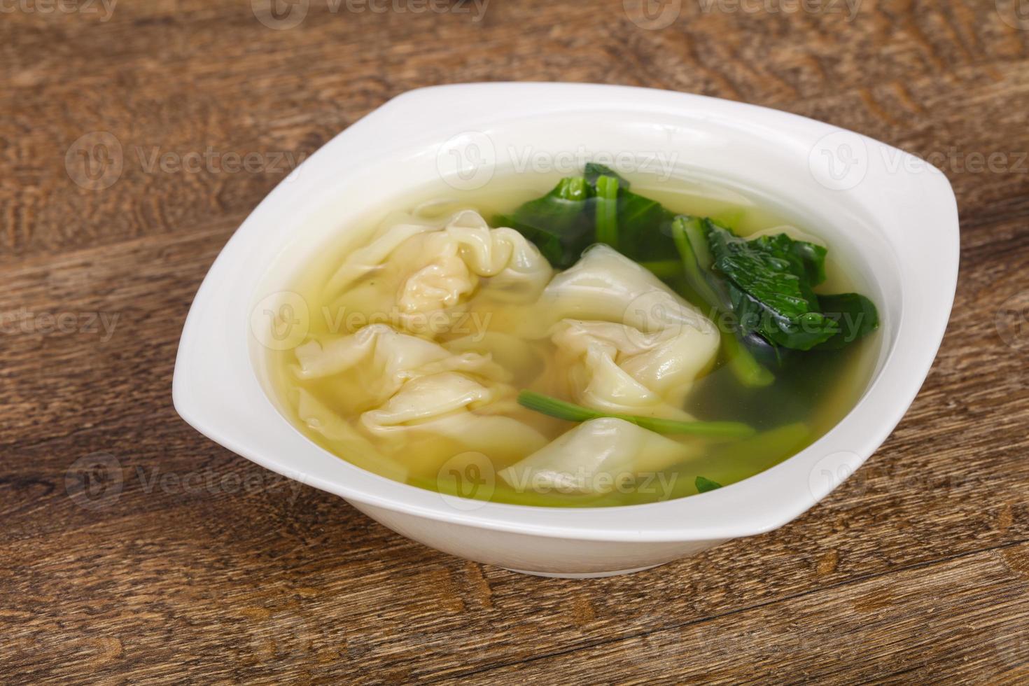 Asian traditional Wonton soup with herbs photo